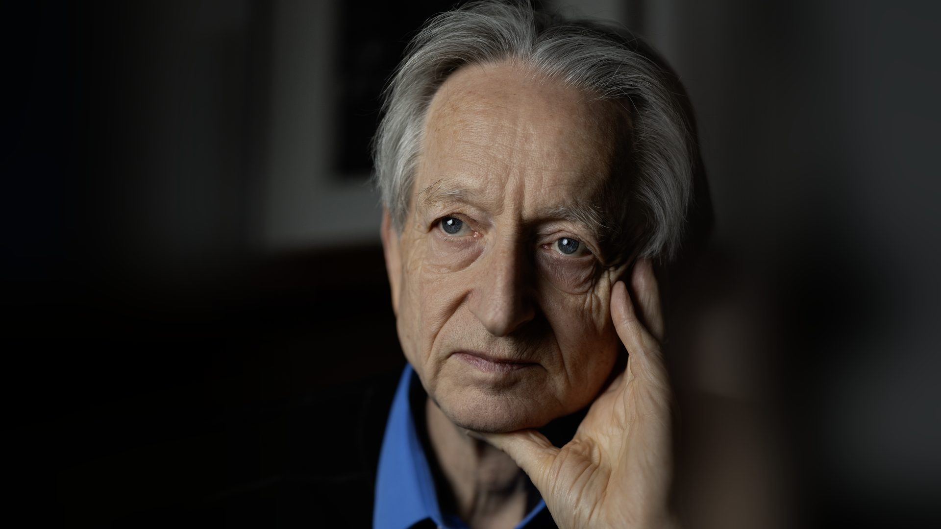 geoffrey hinton ai labor impact: AI pioneer Geoffrey Hinton photographed in 2026, resting his hand against his face