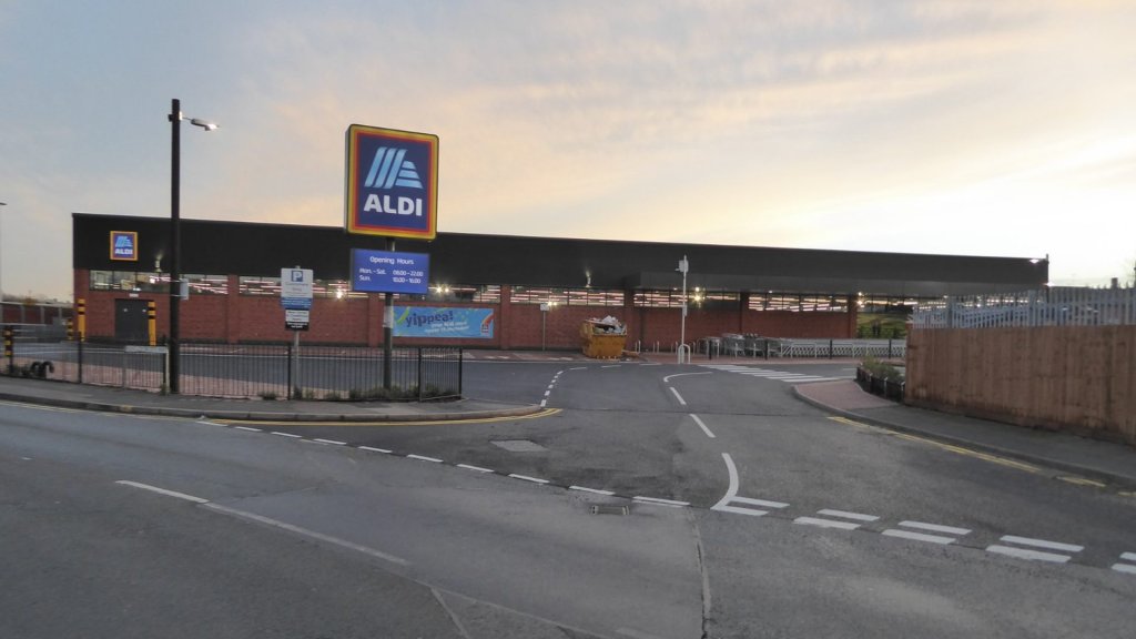 Aldi AI customer service response: an Aldi store lit at dusk with the ALDI sign above the car park