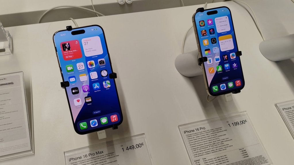 smartphone ai settlement: iPhone 16 Pro and iPhone 16 Pro Max on display in an electronics store