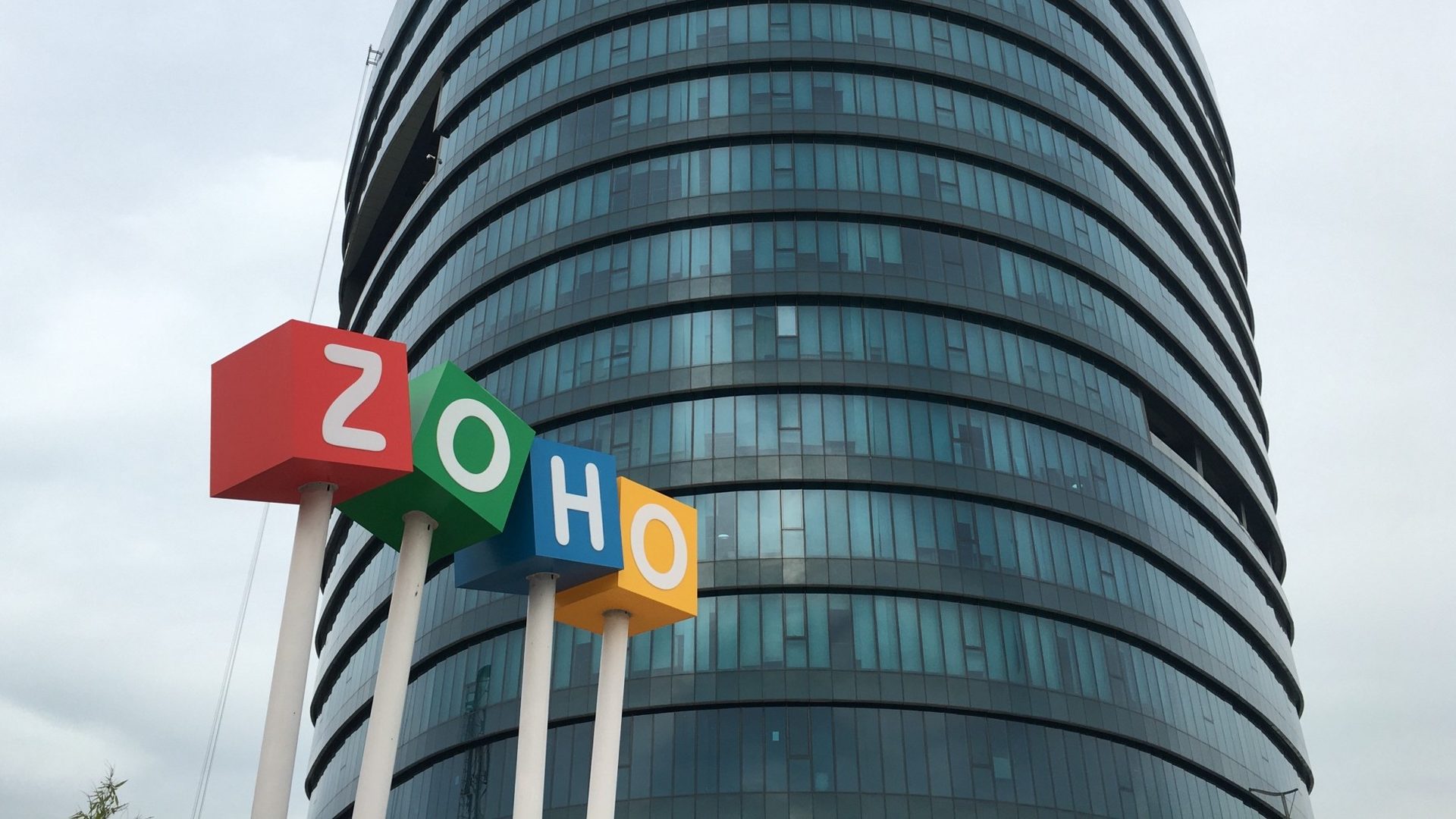 Zoho Sridhar Vembu AI coding warning: the Zoho logo cubes in front of the Zoho headquarters tower in Chennai