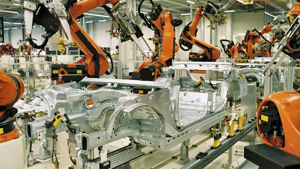 AI gradual disempowerment risks: robot arms building car bodies on an automated BMW assembly line