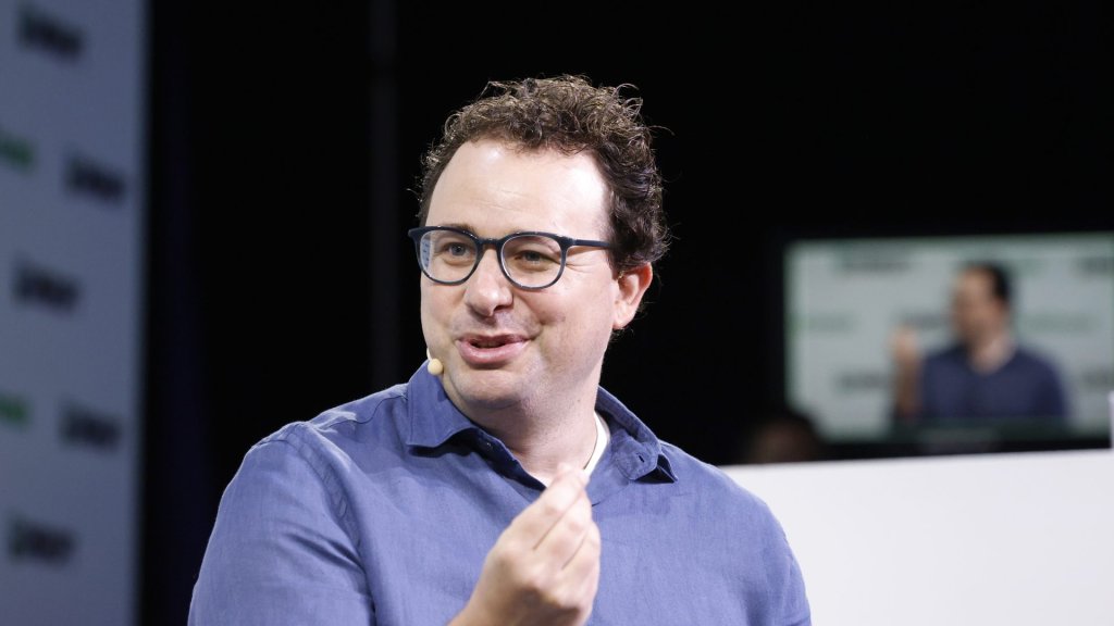 anthropic ai labor and consciousness: Anthropic CEO Dario Amodei speaking on stage at TechCrunch Disrupt 2023