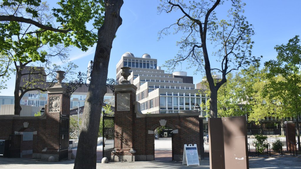 Claude AI scientific research Harvard: the Harvard Science Center seen through a brick gate from Harvard Yard
