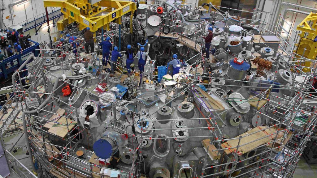 google ai plasma confinement research: the Wendelstein 7-X stellarator torus hall during assembly