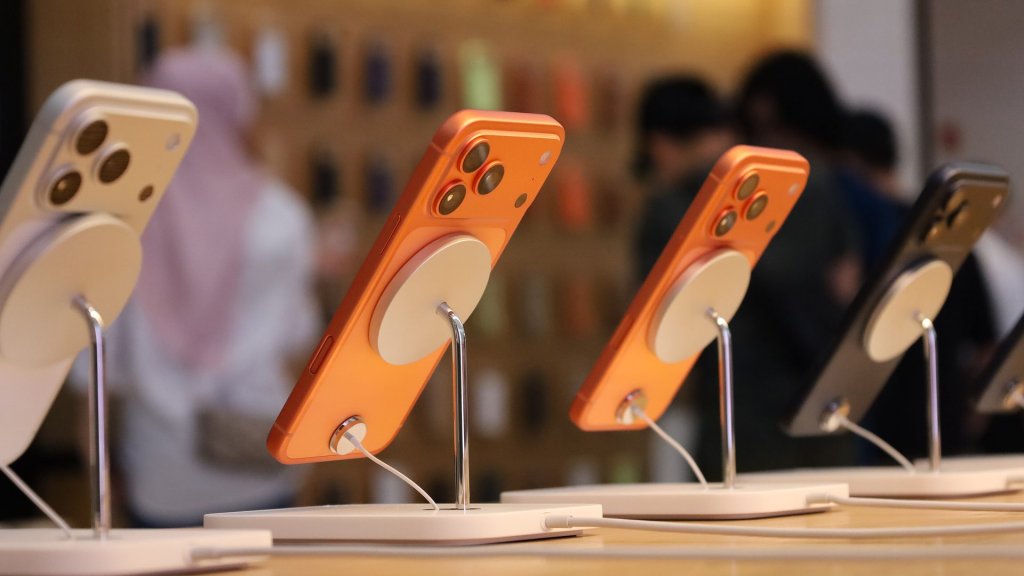ios 27.2 siri ai: new iPhone 17 models on display stands in an Apple Store