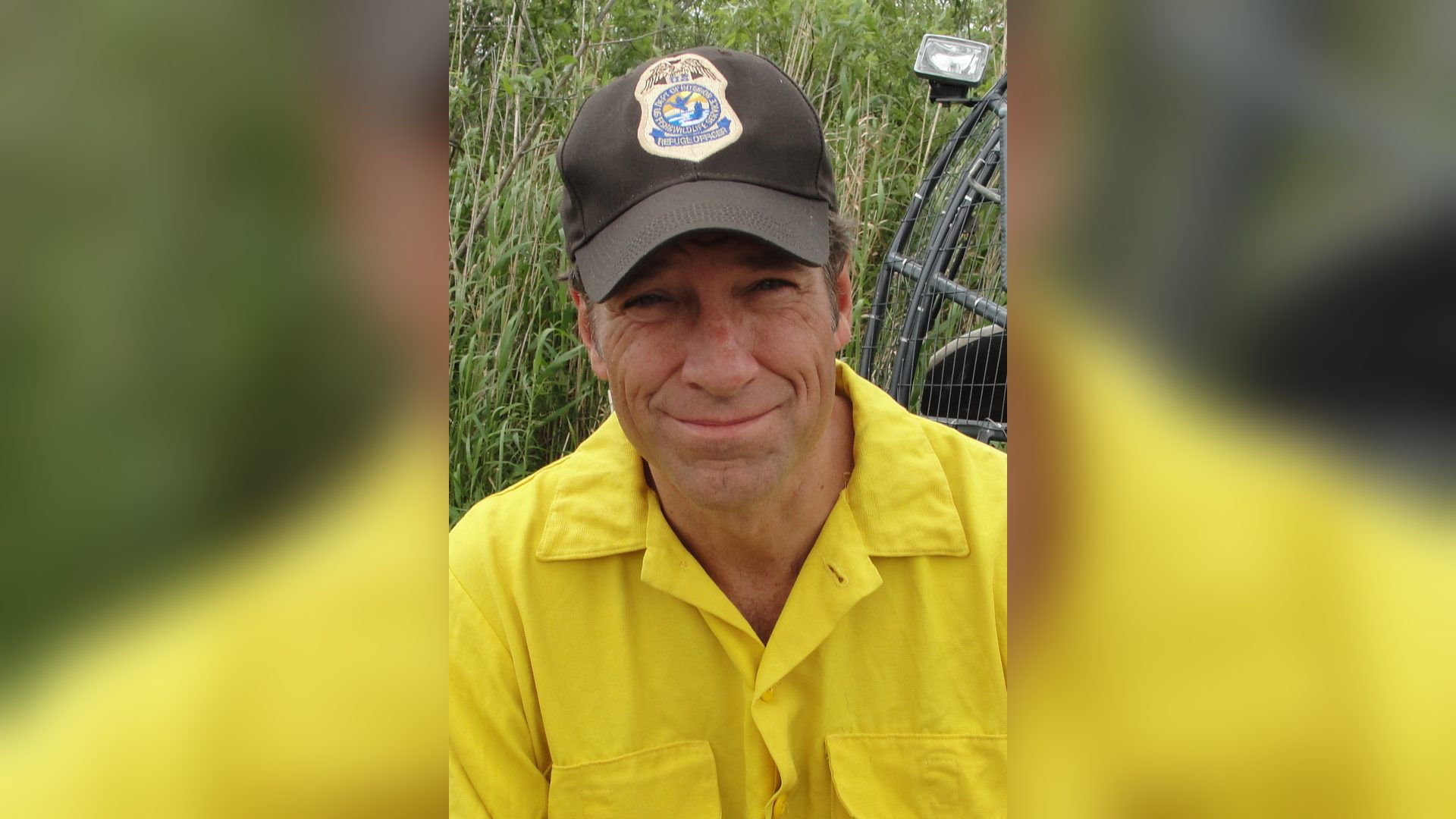 mike rowe skilled trades ai impact: Mike Rowe in a cap and yellow work shirt, smiling outdoors