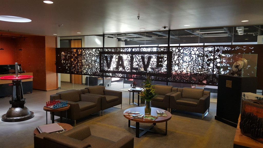 valve stance on ai games: the Valve lobby with its cut-metal VALVE sign at the company office
